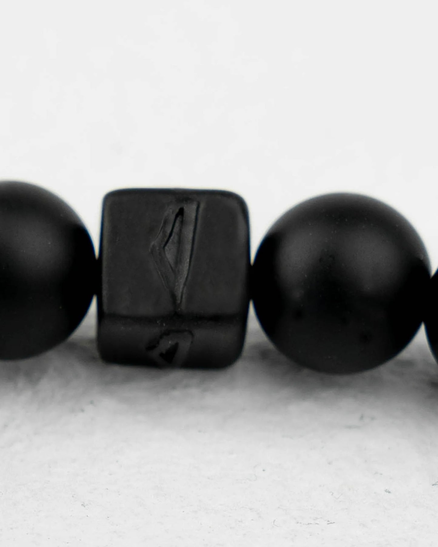 A black stone bracelet featuring a small black stone accent, elegantly designed with a minimalist look.